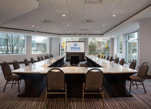 a large conference room with a large table and chairs at Hilton Vancouver Metrotown in Burnaby