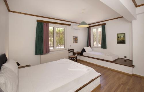 a room with two beds and a couch in it at KORALIA MARATHON VILLA in Nea Makri