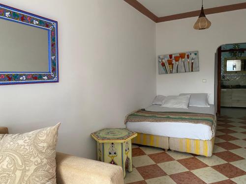 a small bedroom with a bed and a couch at Cabano beach in Tangier