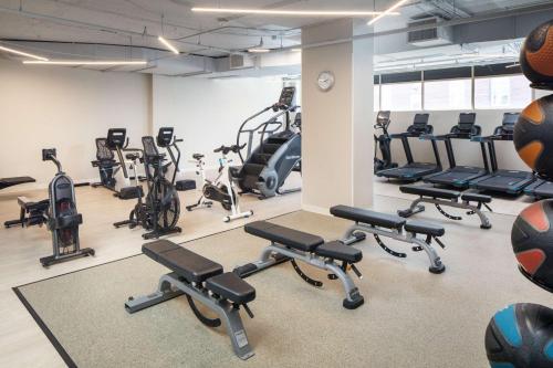 a gym with rows of exercise bikes and tread machines at The Bethesdan Hotel, Tapestry Collection by Hilton in Bethesda