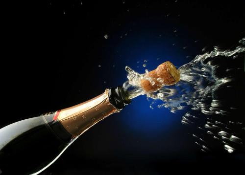 a bottle of champagne being opened with a piece of food at Homewood Suites by Hilton Baltimore in Baltimore