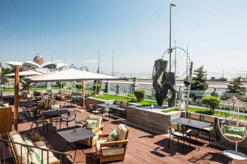 a rooftop patio with tables and chairs and a fountain at Sheraton Baku Intourist in Baku