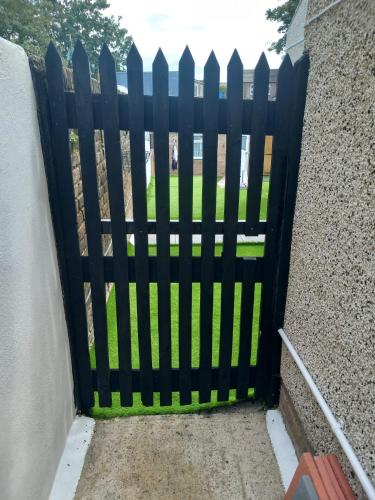 a black gate with green grass behind it at Heronsgate GH013 in Erith