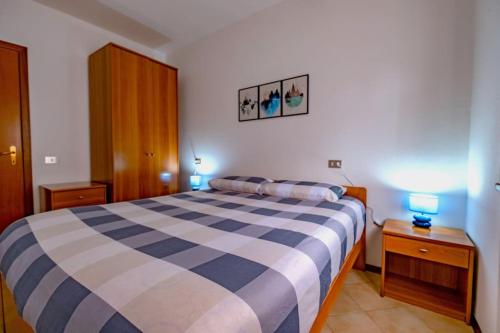 1 dormitorio con 1 cama azul y blanca y 2 lámparas en Happy Guest Apartments - Mountain Panorama Borno, en Borno