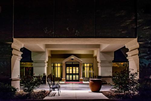 a building with two chairs in front of it at night at Hampton Inn & Suites Nashville Franklin in Franklin