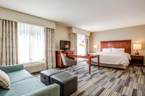 a hotel room with a bed and a desk at Hampton Inn & Suites Westford-Chelmsford in Westford