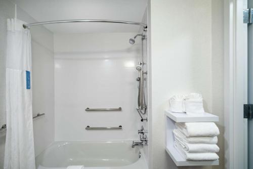 a bathroom with a shower and a sink and towels at Hampton Inn & Suites Nashville Franklin in Franklin