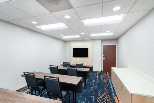 a conference room with tables and chairs and a tv at Hampton Inn & Suites Nashville Franklin in Franklin