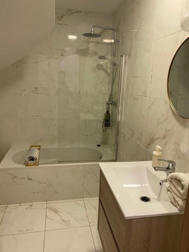a bathroom with a tub and a sink and a shower at El nido del Chorro in Málaga