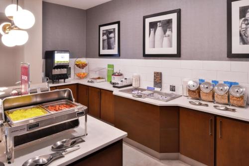 a restaurant kitchen with a buffet with food at Hampton Inn & Suites Legacy Park-Frisco in Frisco