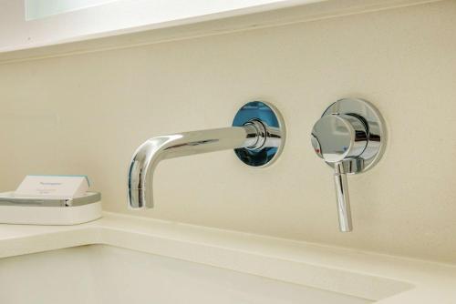 a bathroom sink with a faucet and a mirror at Hampton Inn & Suites Legacy Park-Frisco in Frisco