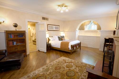 a bedroom with a bed and a room with a window at Mansion Hill Inn in Madison