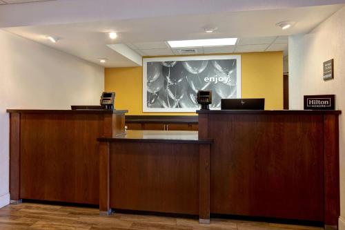 a lobby with two desks and a chalkboard on the wall at Hampton Inn Fort Wayne-Southwest in Fort Wayne