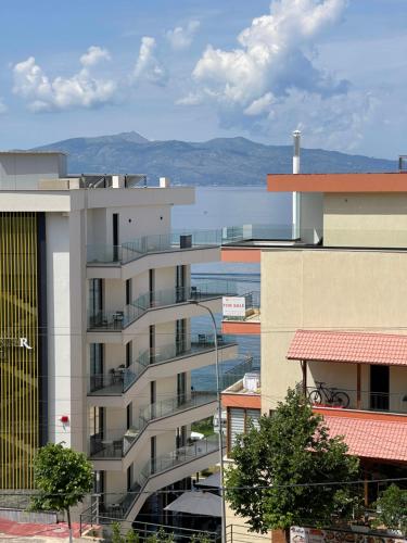 an apartment building with a view of a body of water at Overview Apartments Saranda in Sarandë