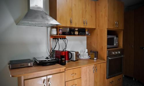 a kitchen with wooden cabinets and a stove top oven at 1 Bedroom house we call home in Tarshīhā