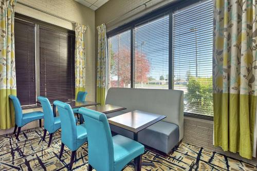 a waiting room with a table and chairs and a window at Hampton Inn Norfolk-Naval Base in Norfolk
