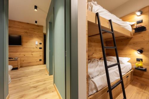 a bunk bed in a room with a ladder at Maison Luboz - Courmayeur in Courmayeur