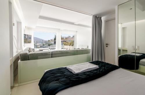 a bedroom with a bed and a large window at Kolonaki Square Panorama Penthouse in Athens