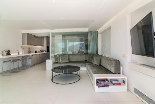 a living room with a couch and a table at Kolonaki Square Panorama Penthouse in Athens