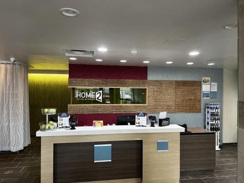a lobby with a counter with a home pharmacy at Home2 Suites By Hilton Hinesville in Hinesville