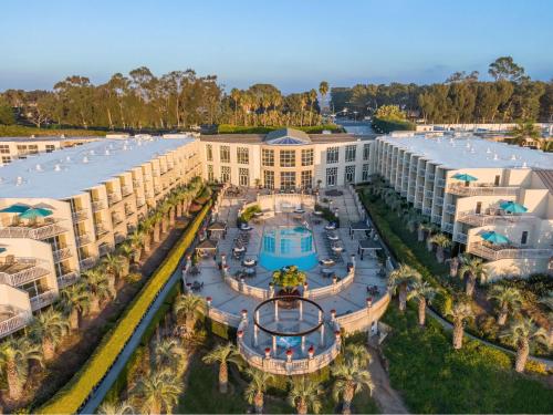 an aerial view of a resort with a pool and palm trees at Hilton La Jolla Torrey Pines in San Diego
