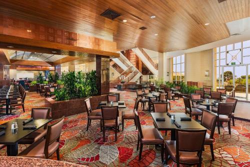 a dining room with tables and chairs in a restaurant at Hilton La Jolla Torrey Pines in San Diego
