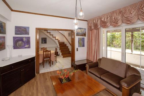 a living room with a couch and a table at KORALIA MARATHON VILLA in Nea Makri