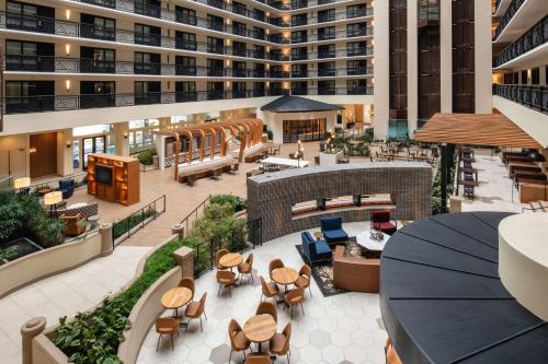 an overhead view of a hotel lobby with tables and chairs at Embassy Suites by Hilton San Francisco Airport Oyster Point in South San Francisco