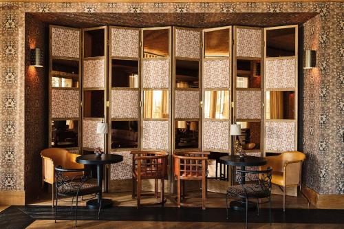 a room with tables and chairs and a wall of mirrors at Austin Proper Hotel, a Member of Design Hotels in Austin