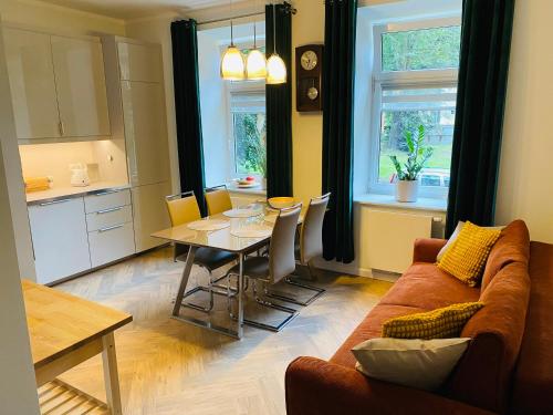 ein Wohnzimmer mit einem Sofa und einem Tisch in der Unterkunft Apartament Pod Lipami in Olsztyn