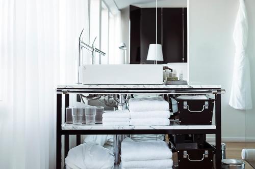 a towel rack with towels and a sink in a bathroom at 101 Hotel, a Member of Design Hotels in Reykjavík