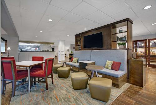 a living room with a table and chairs and a tv at Hampton Inn Salisbury in Salisbury