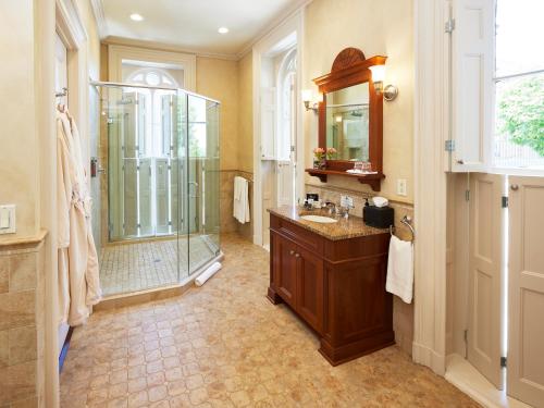 a bathroom with a shower and a sink and a mirror at Mansion Hill Inn in Madison