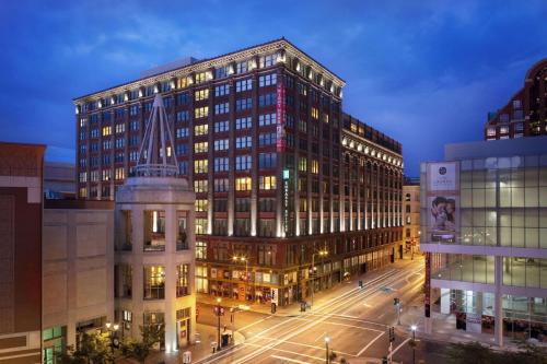 a large building in a city at night at Embassy Suites Saint Louis - Downtown in Saint Louis