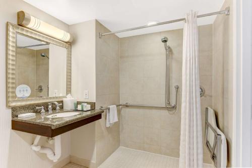 a bathroom with a sink and a shower at Hilton Irvine/Orange County Airport in Irvine