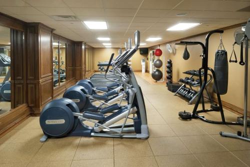 a gym with a row of treadmills and machines at President Abraham Lincoln - A Doubletree by Hilton Hotel in Springfield