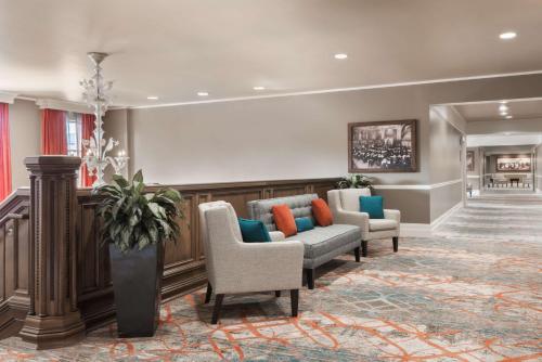 a waiting room with couches and chairs in a lobby at President Abraham Lincoln - A Doubletree by Hilton Hotel in Springfield