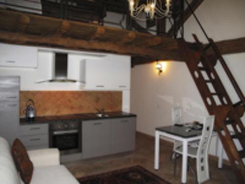 a living room with a kitchen and a dining room table at Agriturismo Villa Anconetta in Loreo
