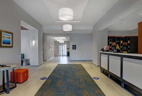 a room with a hallway with a table and a rug at Hampton Inn & Suites Belleville in Belleville