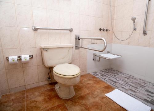 a bathroom with a toilet and a shower at La Quinta by Wyndham Quito in Quito