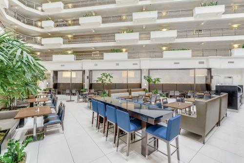 a dining room with tables and blue chairs at Embassy Suites by Hilton Anaheim-Orange in Anaheim