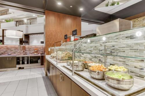 a kitchen with a counter with many baskets of food at Embassy Suites by Hilton Anaheim-Orange in Anaheim