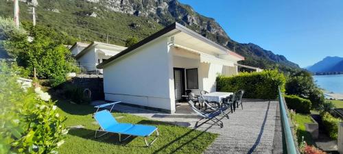 a house with a patio with chairs and a table at Holiday Apartment Anna 63 Idro in Anfo