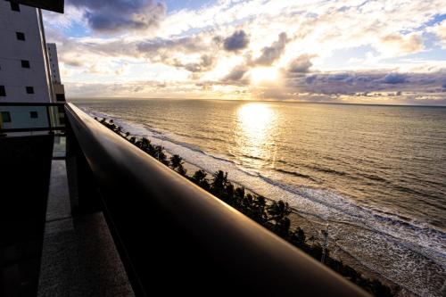 a view of the ocean at sunset from a building at Nobile Residences Maria Frazão in Recife