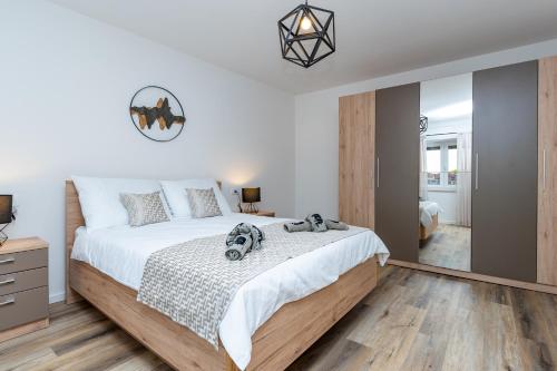 a bedroom with a large bed and a mirror at Villa Antique in Novi Vinodolski
