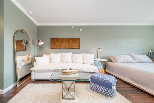 a bedroom with two beds and a coffee table at The Olive Tree Loft in Hot Springs