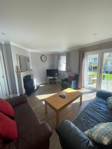 a living room with a couch and a coffee table at Faithlegg Estate, Mews Holiday Home, Waterford in Waterford