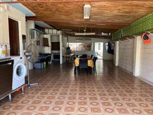 a kitchen with a table and a dining room at Kaza Ohana proche de Malendure - maison 8 à 11 personnes in Bouillante
