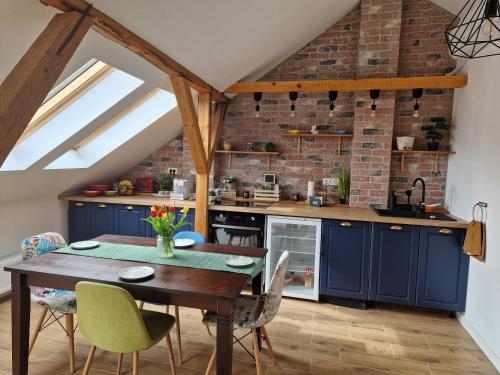 a kitchen with blue cabinets and a wooden table at Casa Ileana 