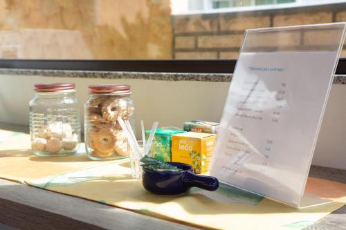 a table with jars and a sign on it at Conves suites in Penha